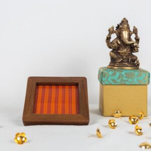 Fanta orange Kanchipuram silk with the good old stripes in a natural finish teak frame coaster.