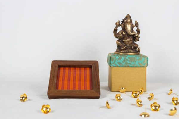 Fanta orange Kanchipuram silk with the good old stripes in a natural finish teak frame coaster.