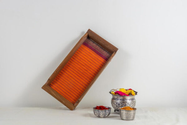 Small tray inlaid with a fanta orange Kanchipuram silk with a deep maroon border.