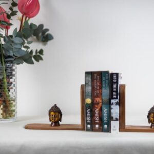 Burma teak book end with brass Buddha heads from Uttar Pradesh.