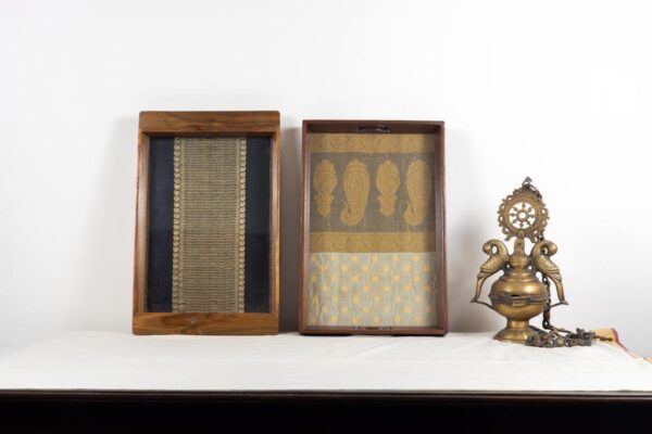 Left: Black and gold vairaoosi Kanchipuram silk inlaid in a 100 year old Burma teak frame. Right: large Burma teak tray, inlaid with a cream and gold Banaras tissue organza with traditional woven motifs.