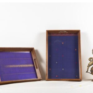 Left Violet Puneri silk with zari and threadwork inlaid in a 100 year old Burma teak frame. Right: A deep blue Kanchipuram silk with thread work buttis ( motifs) and border in a Burma teak frame.