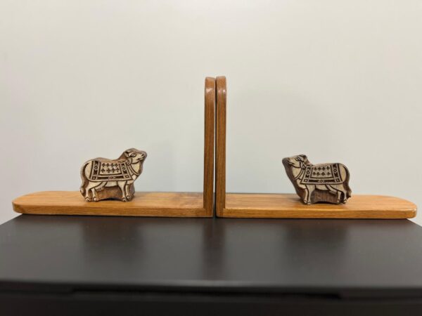 bookend has cow shaped block printing blocks on a 100 year old Burma teak.