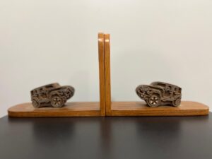 100 year old Burma teak book ends embellished with car shaped block printing blocks.